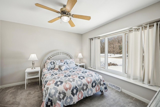 bedroom featuring ceiling fan, dark carpet, visible vents, and baseboards