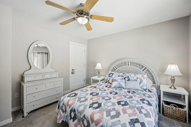 carpeted bedroom with ceiling fan and baseboards