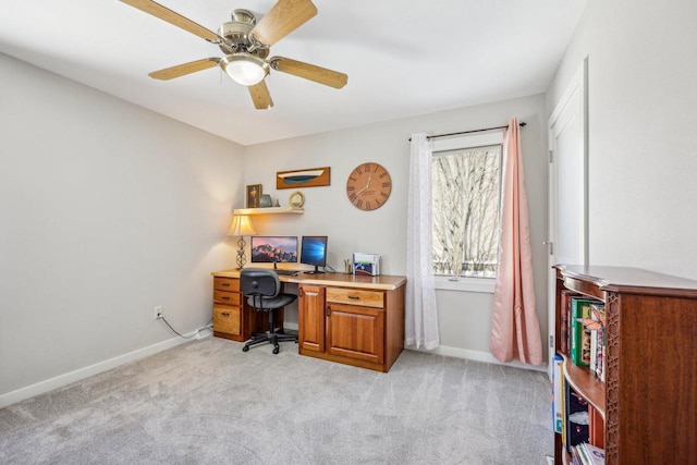 office area featuring light carpet, ceiling fan, and baseboards