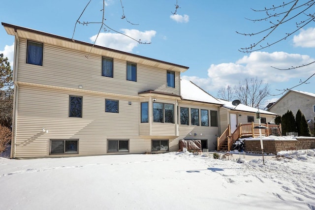 view of snow covered back of property