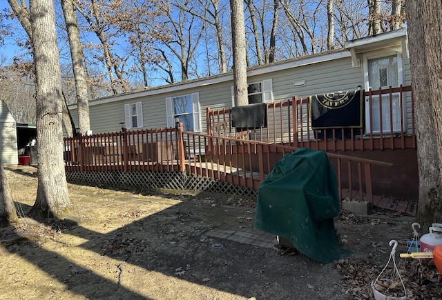 back of house with a wooden deck