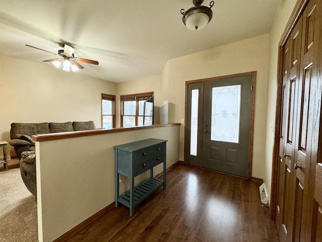 entrance foyer featuring ceiling fan, baseboards, visible vents, and dark wood finished floors