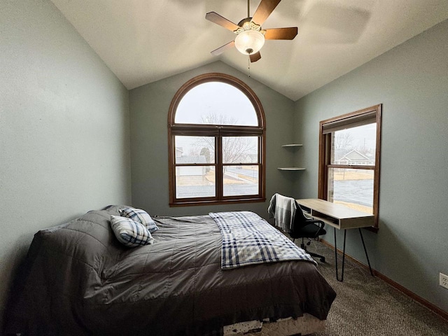 carpeted bedroom featuring a ceiling fan, vaulted ceiling, and baseboards