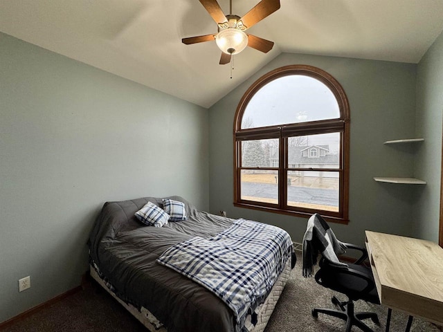 carpeted bedroom with vaulted ceiling, a ceiling fan, and baseboards