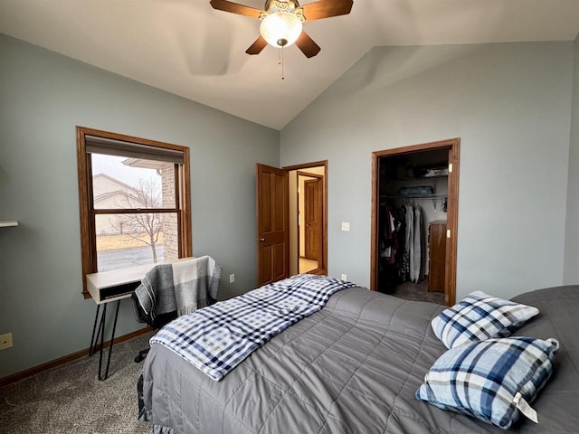 carpeted bedroom with baseboards, a ceiling fan, lofted ceiling, a spacious closet, and a closet