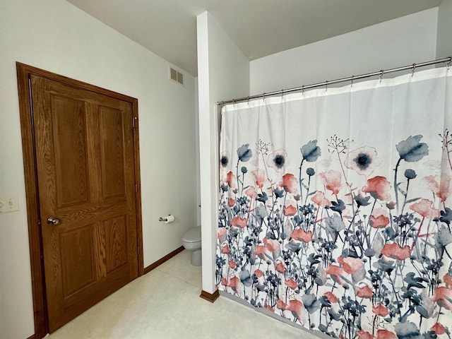 full bath featuring toilet, a shower with shower curtain, visible vents, and baseboards