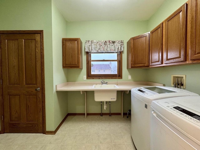 washroom with washing machine and clothes dryer, cabinet space, and baseboards