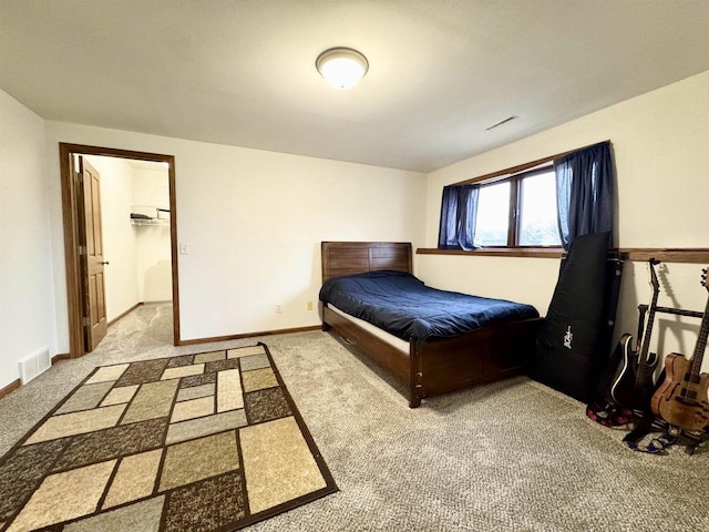 carpeted bedroom with baseboards and visible vents