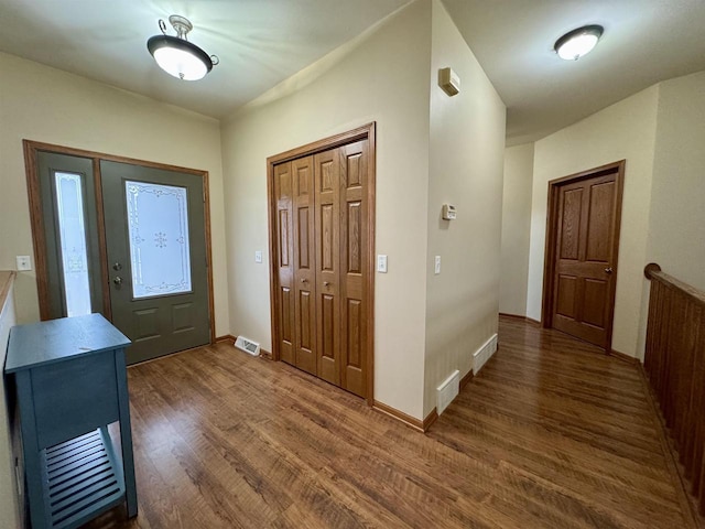 foyer with visible vents, baseboards, and wood finished floors