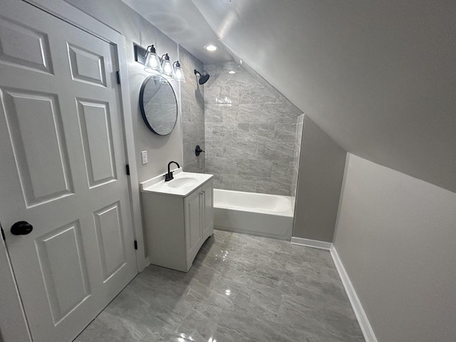 bathroom with marble finish floor, shower / bathing tub combination, vanity, and baseboards