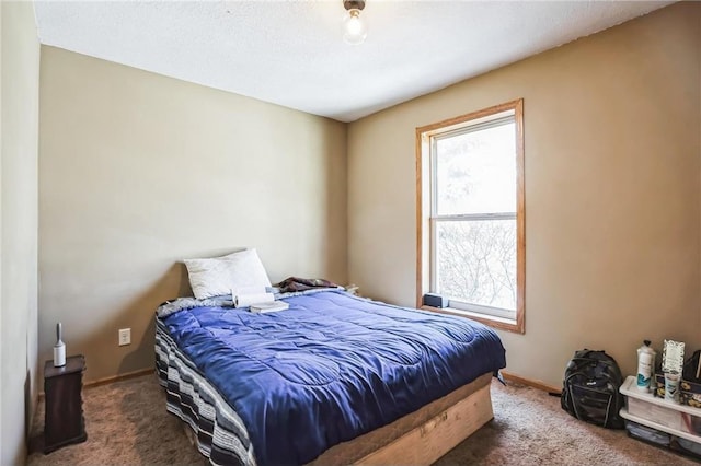 bedroom featuring carpet floors and baseboards