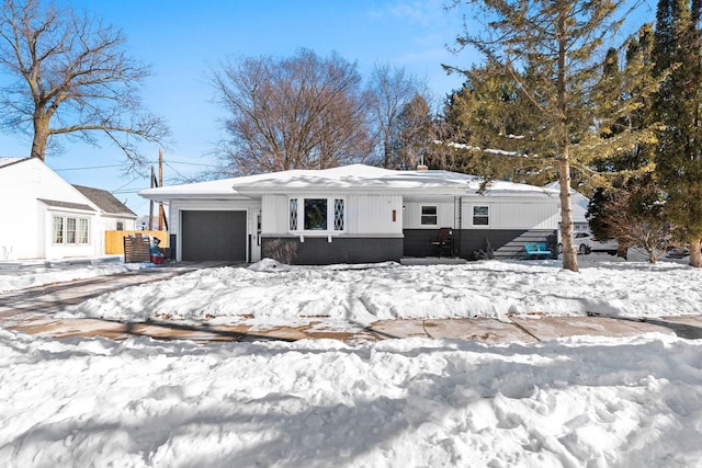 view of front of property with a garage and brick siding