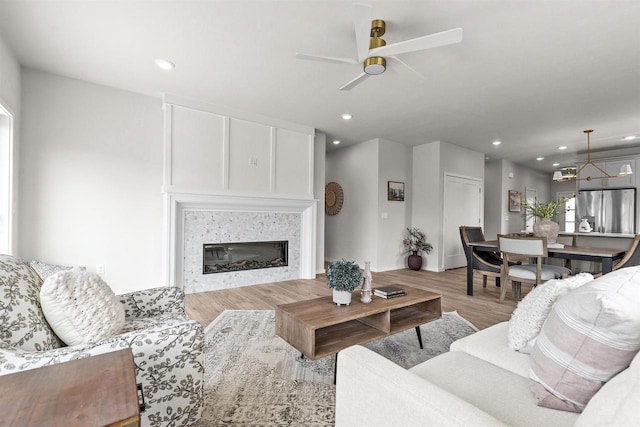 3687 Callalilly Ln, Appleton, WI 54913 - living area featuring ceiling fan, light wood-style floors, a glass covered fireplace, and recessed lighting