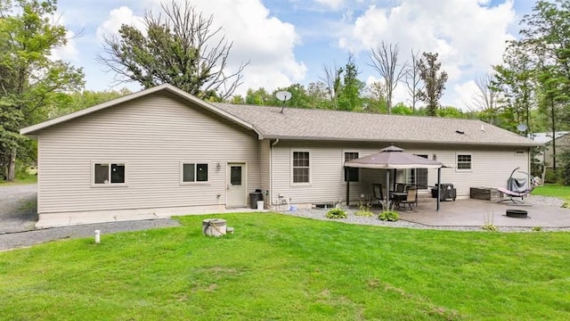 rear view of property featuring a yard, a patio, and a gazebo