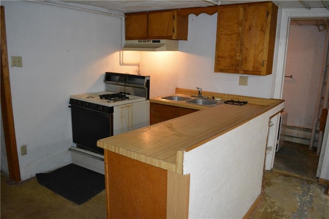 kitchen with white range with gas stovetop, brown cabinetry, light countertops, under cabinet range hood, and a sink