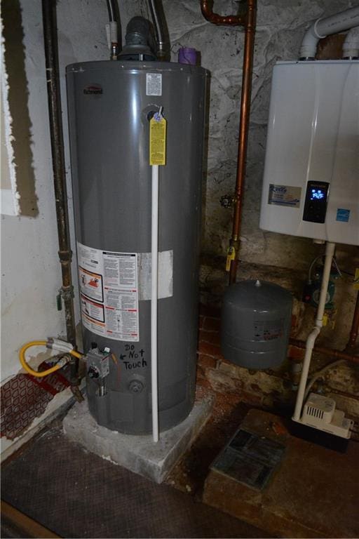 utility room with gas water heater and water heater