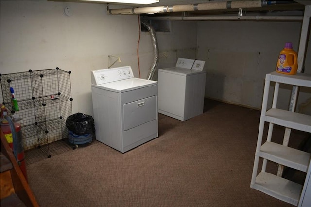 washroom with washer and dryer, laundry area, and dark carpet