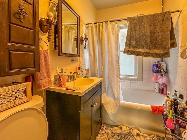 full bathroom with toilet, shower / bathtub combination with curtain, and vanity