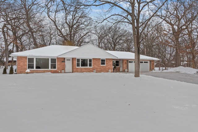 ranch-style home with brick siding and an attached garage