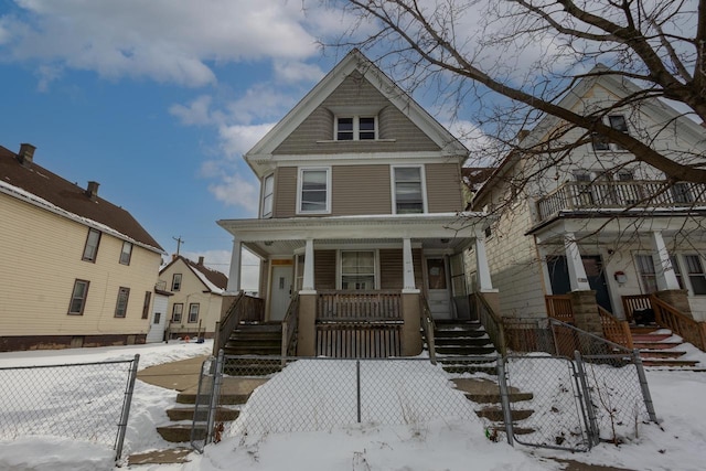 view of front of home featuring a fenced front yard and a porch