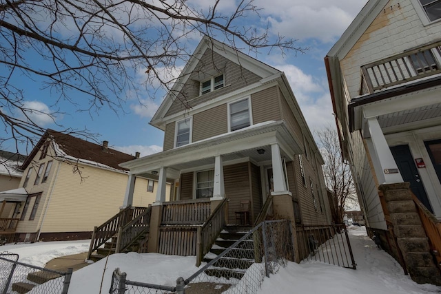 american foursquare style home with a porch