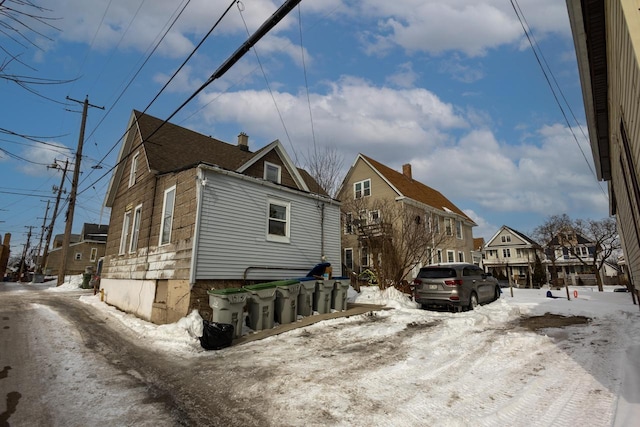 view of snowy exterior featuring a residential view