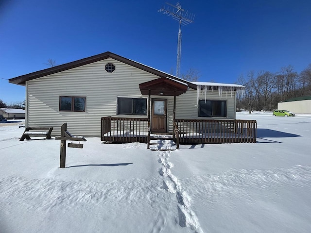 view of snow covered rear of property