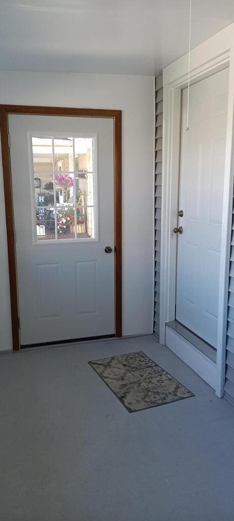 doorway to outside featuring finished concrete flooring