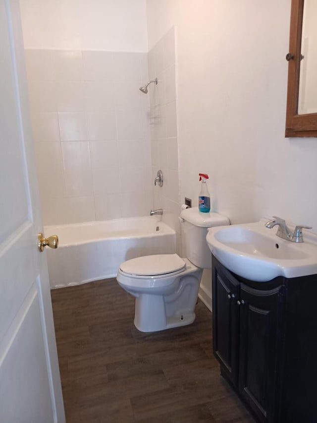 full bathroom with toilet, shower / tub combination, wood finished floors, and vanity