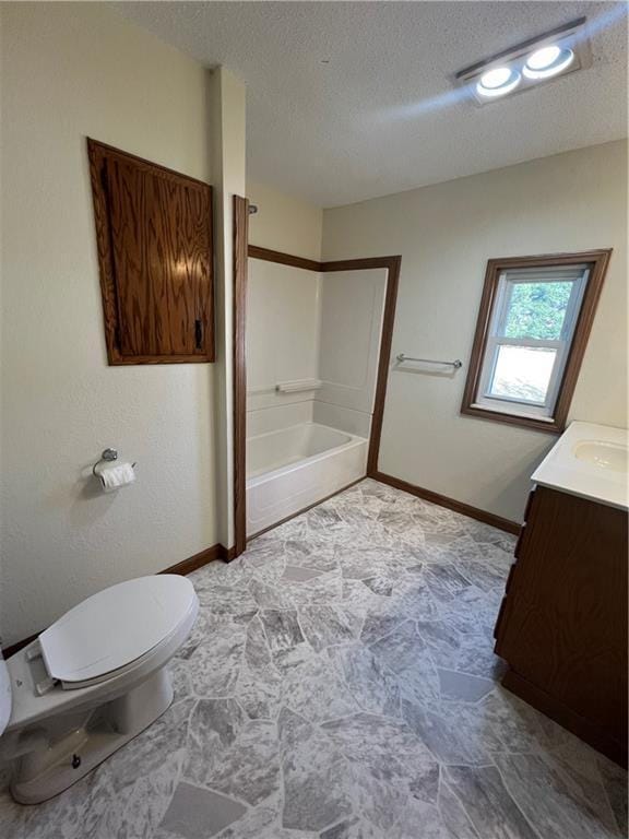 full bathroom featuring a textured ceiling, toilet, vanity, baseboards, and  shower combination