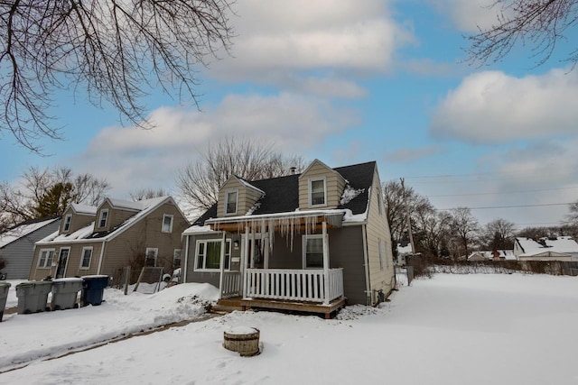 snow covered house with covered porch