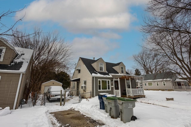 exterior space with a garage, covered porch, and fence