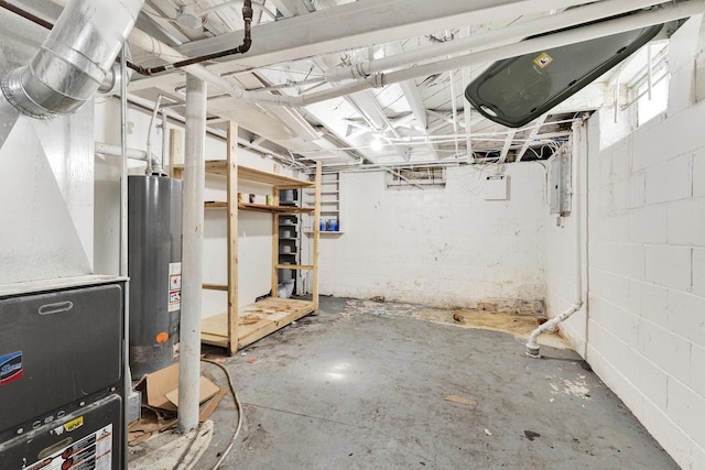 unfinished basement featuring concrete block wall and gas water heater