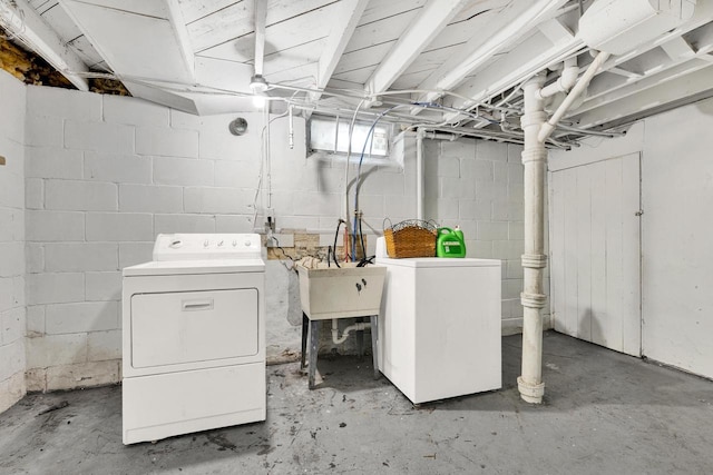 laundry area featuring washer and dryer, laundry area, and a sink