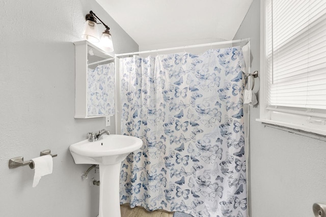 bathroom with a sink and a shower with shower curtain