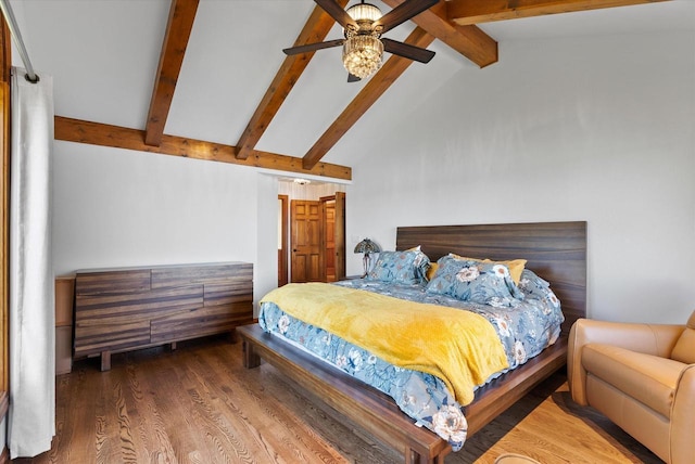 bedroom with a ceiling fan, lofted ceiling with beams, and wood finished floors