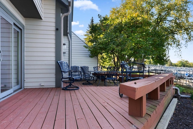 wooden terrace with outdoor dining area