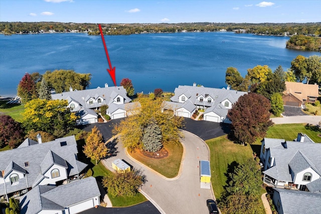 drone / aerial view with a water view and a residential view