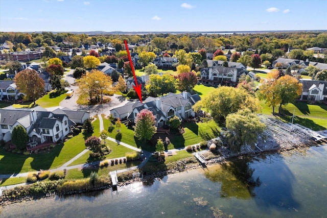 birds eye view of property with a water view and a residential view