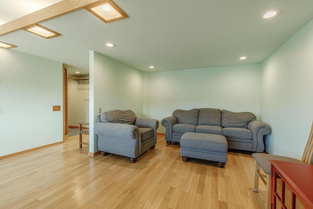 living area featuring light wood-type flooring, baseboards, and recessed lighting