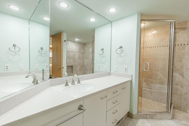 full bathroom featuring a stall shower, tile patterned floors, vanity, and recessed lighting