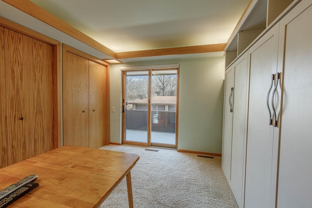 doorway with light carpet, baseboards, and visible vents