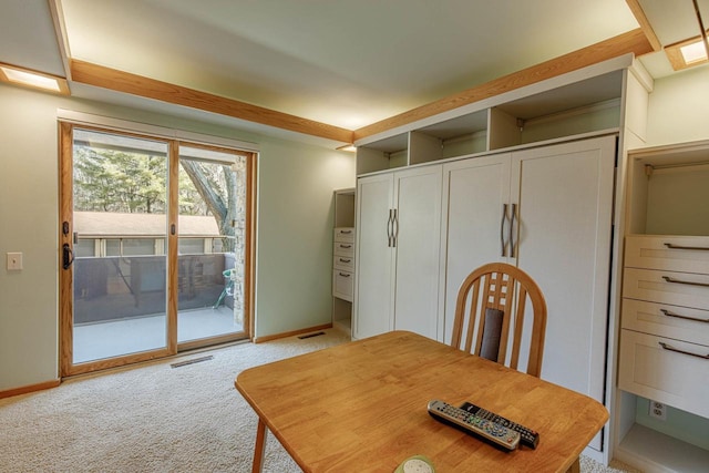 dining room with light carpet, visible vents, and baseboards