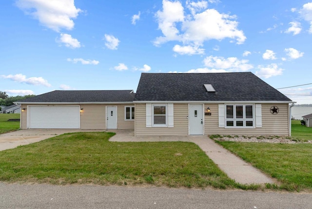 view of front facade with a garage, concrete driveway, a shingled roof, and a front yard