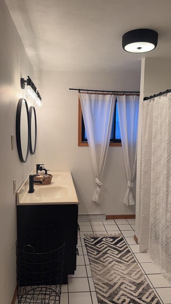 full bath featuring vanity and tile patterned floors