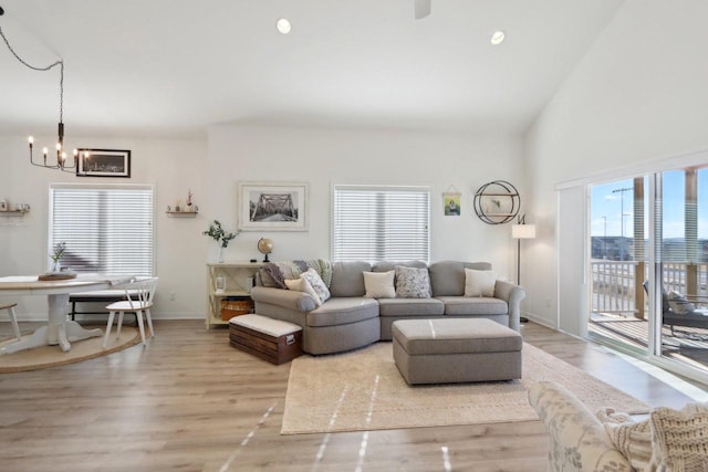 living area with a view of city, recessed lighting, a chandelier, light wood-type flooring, and baseboards