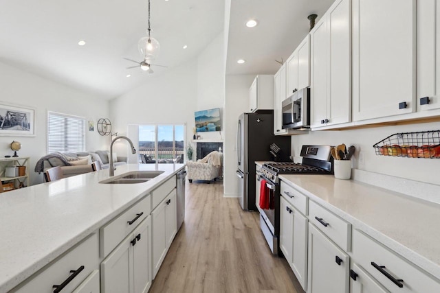 kitchen featuring open floor plan, light countertops, and appliances with stainless steel finishes