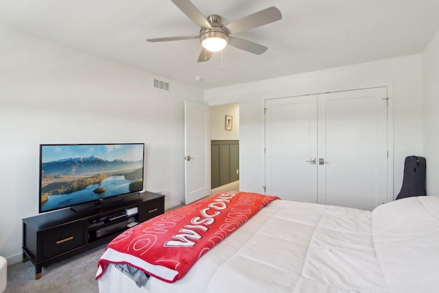 carpeted bedroom with ceiling fan, a closet, and visible vents