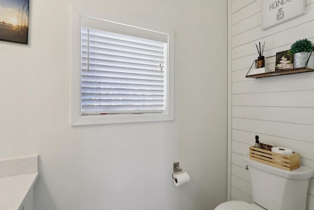 half bathroom with toilet and vanity