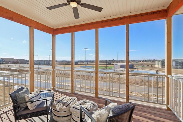 sunroom featuring ceiling fan